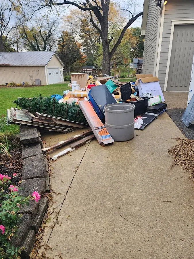Dumpster being loaded with debris for 12 Yard Dumpster Rental in Enterprise